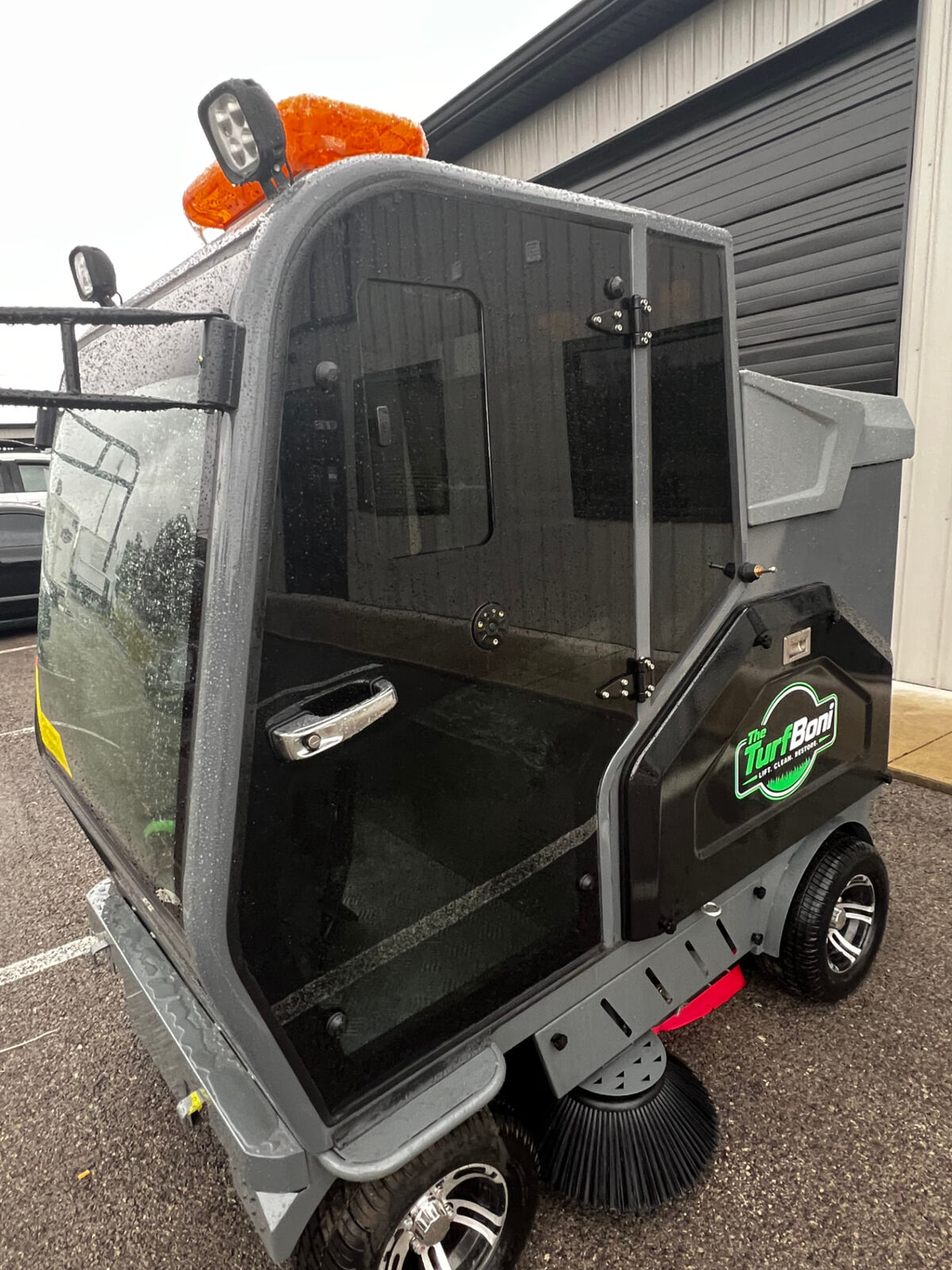 TurfBoni ride-on machine with enclosed cab